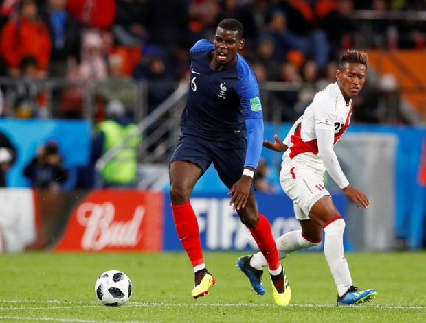 Soccer Football - World Cup - Group C - France vs Peru - Ekaterinburg Arena, Yekaterinburg, Russia - June 21, 2018 France's Paul Pogba in action with Peru's Pedro Aquino REUTERS/Jason Cairnduff