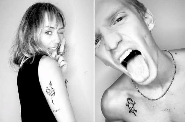Miley Cyrus and Cody Simpson show off their tattoos.