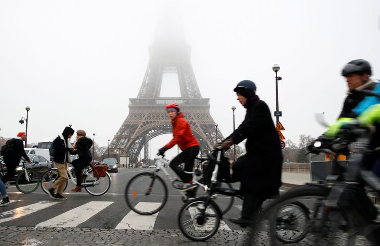 People ride bicycles near the Eiffel Tower during a strike by all unions of the Paris transport network (RATP) as part of a day of national strike and protests against French government's pensions reform plans, France, December 5, 2019. REUTERS